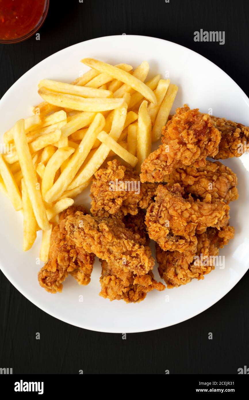 Homemade Crispy Chicken wings and French Fries with soursweet sauce on