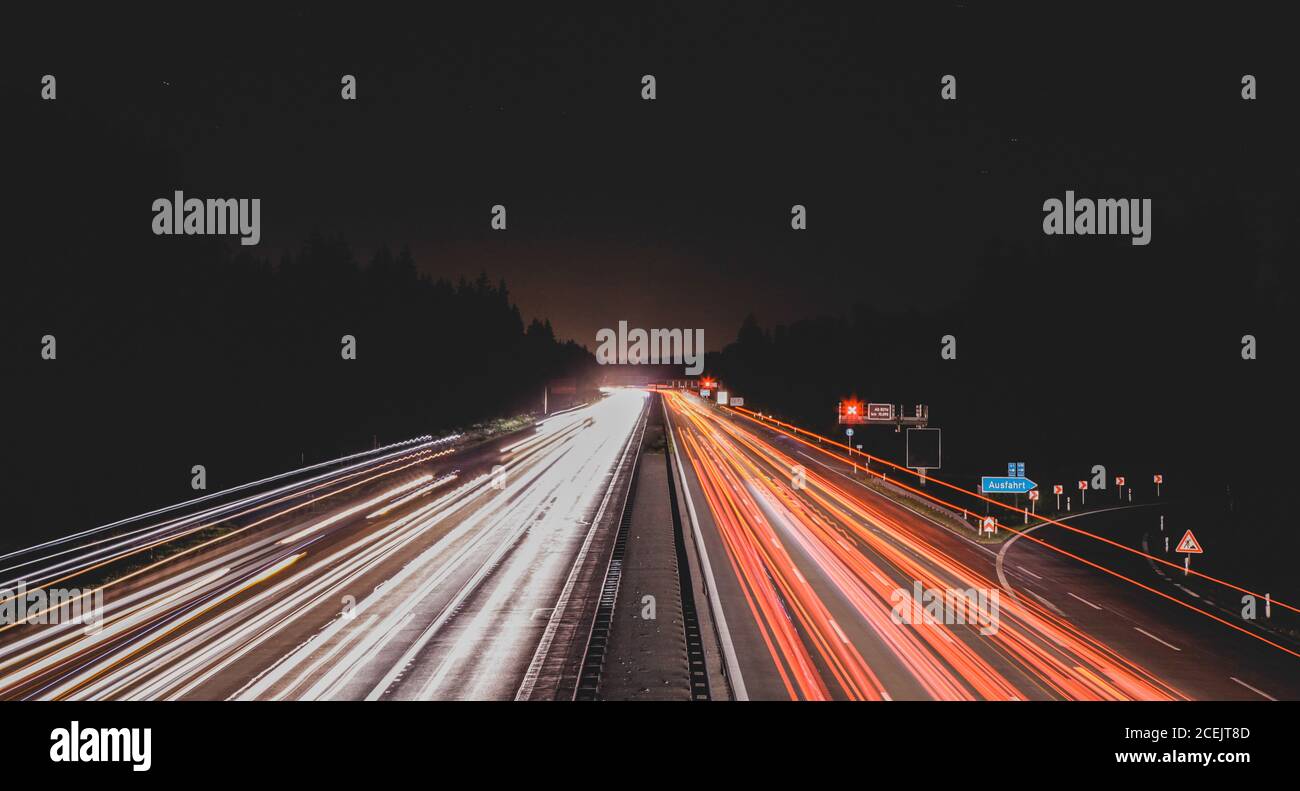 Long exposure shot of bright traces of car lights on busy road at night  Stock Photo - Alamy