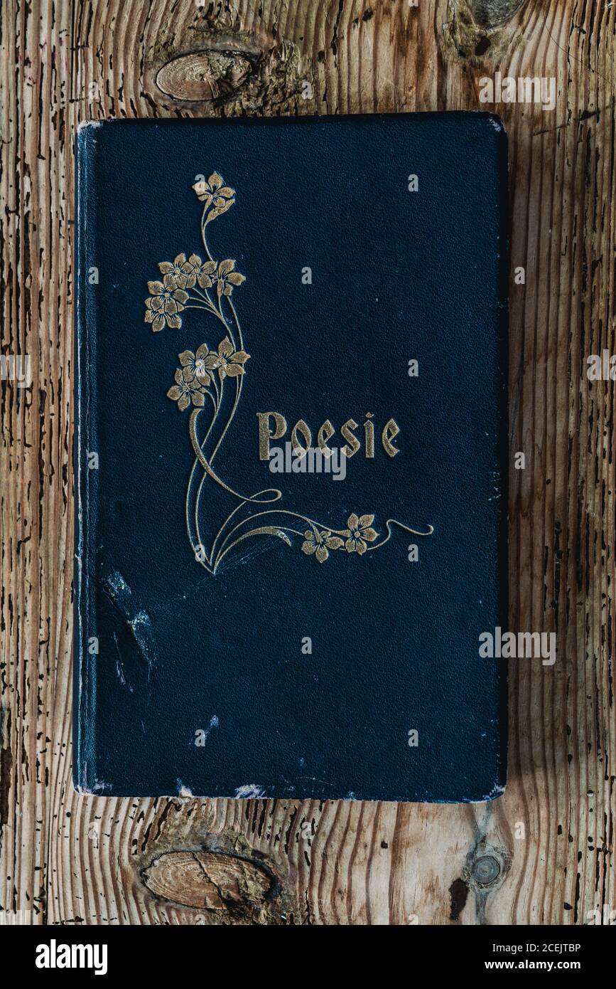From Above View Of Ancient Used Blue Poem Volume Placed On Wood Background Stock Photo Alamy
