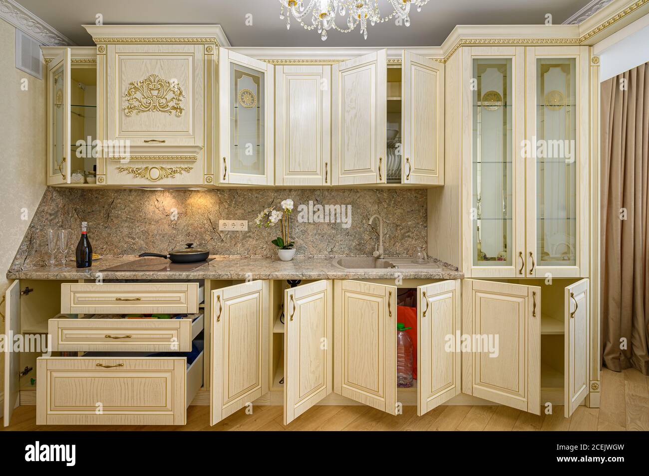 Front view of luxury modern neoclassic beige kitchen interior Stock Photo