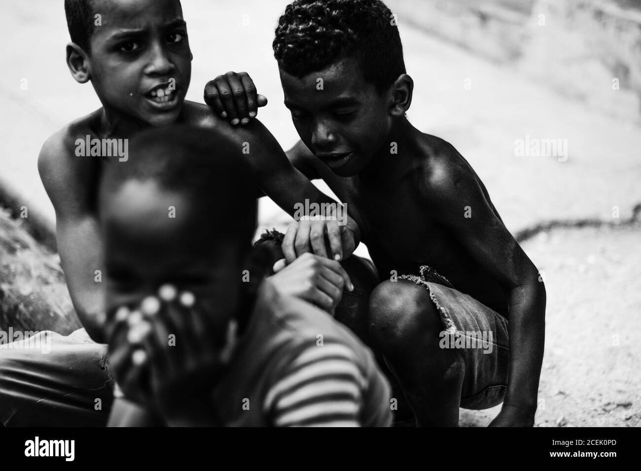 LA HABANA, CUBA - MAY 1, 2018: Black and white shot of ethnic children spending time on street of Cuba city in sunlight. Stock Photo