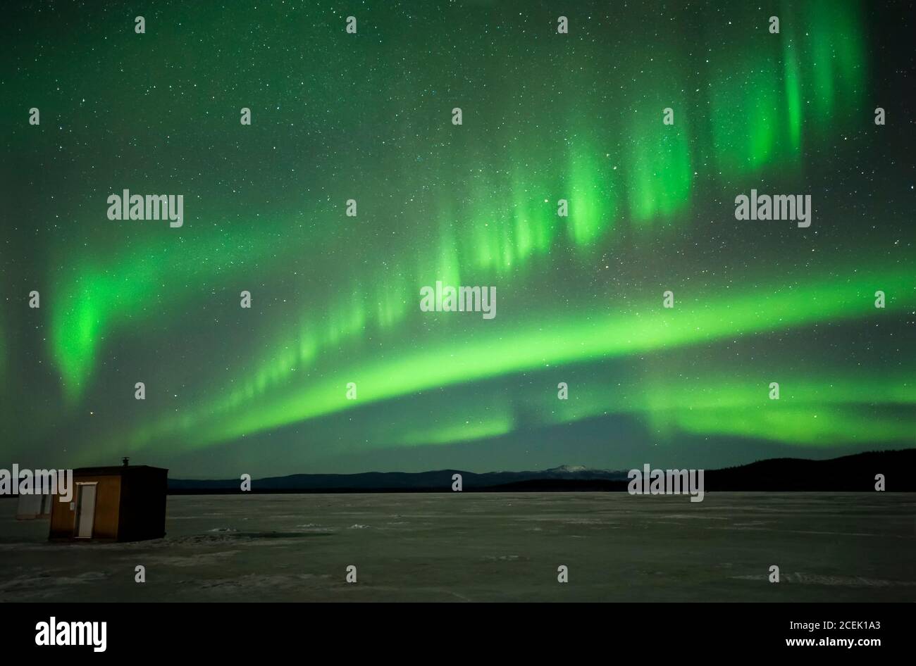 North America; United States; Alaska; Quartz Lake; Winter; Night; Stars; Sky; Natural Phenomenon; Aurora Borealis; Northern Lights. Ice Fishing Houses Stock Photo