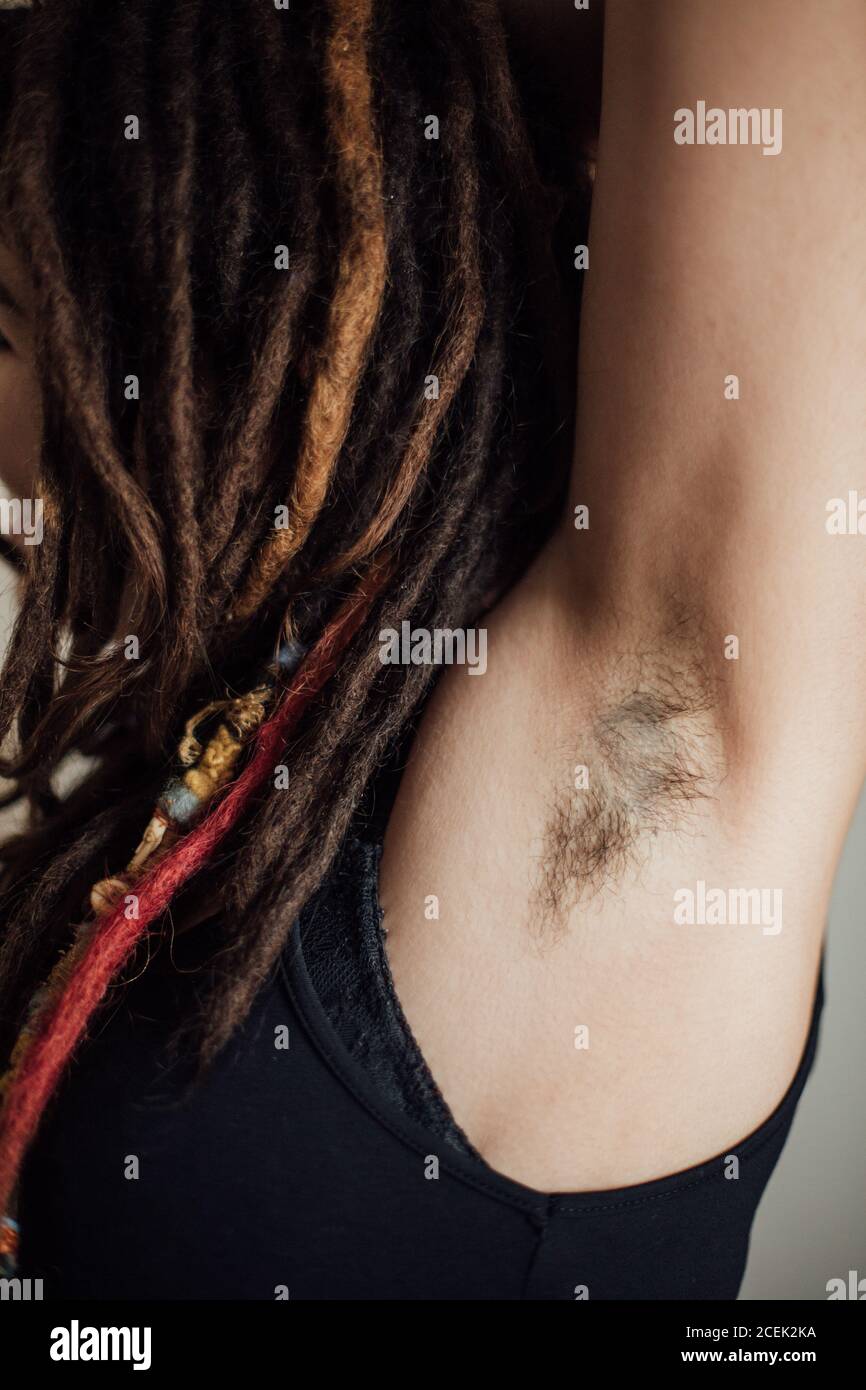 Woman with dreadlocks showing her hairy underarm Stock Photo