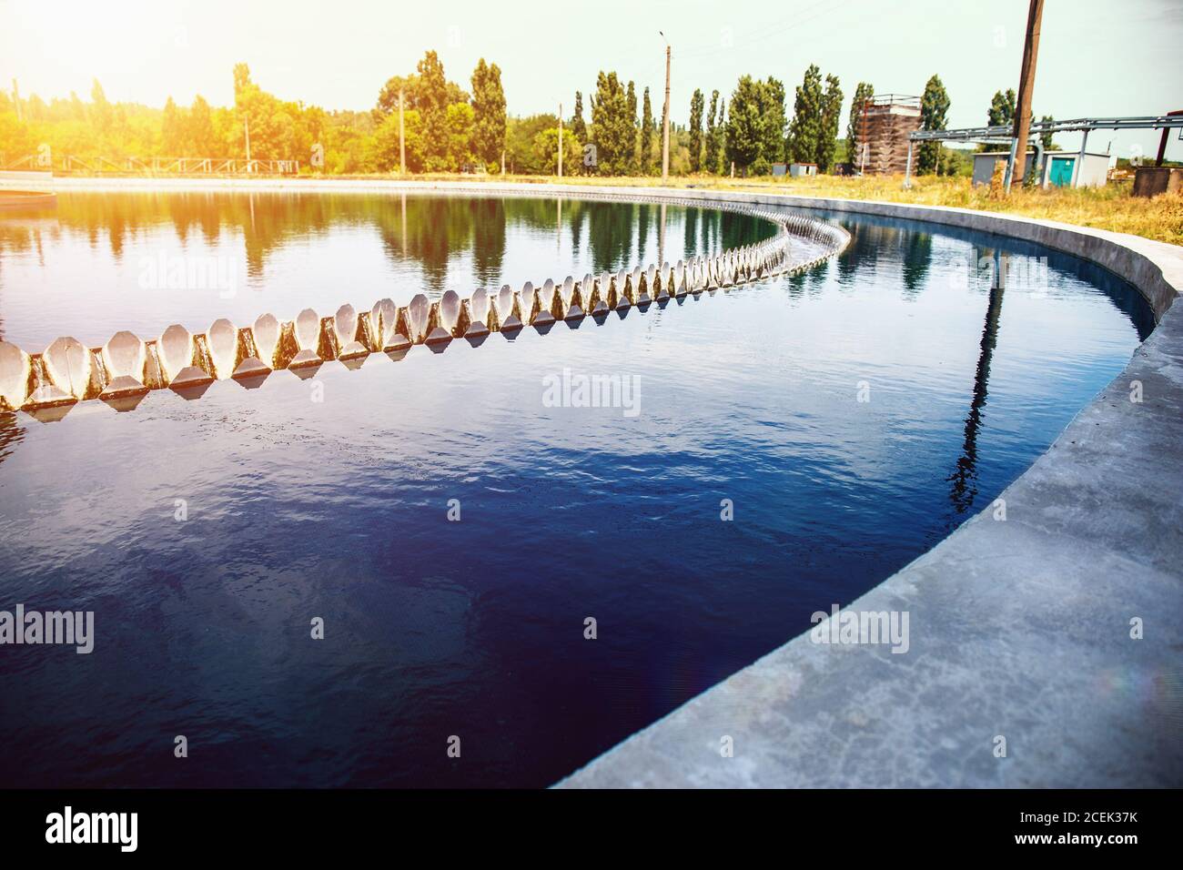 Modern Urban Wastewater Treatment Plant Reservoir In Sunlight Stock modern-urban-wastewater-treatment-plant-reservoir-in-sunlight-stock
