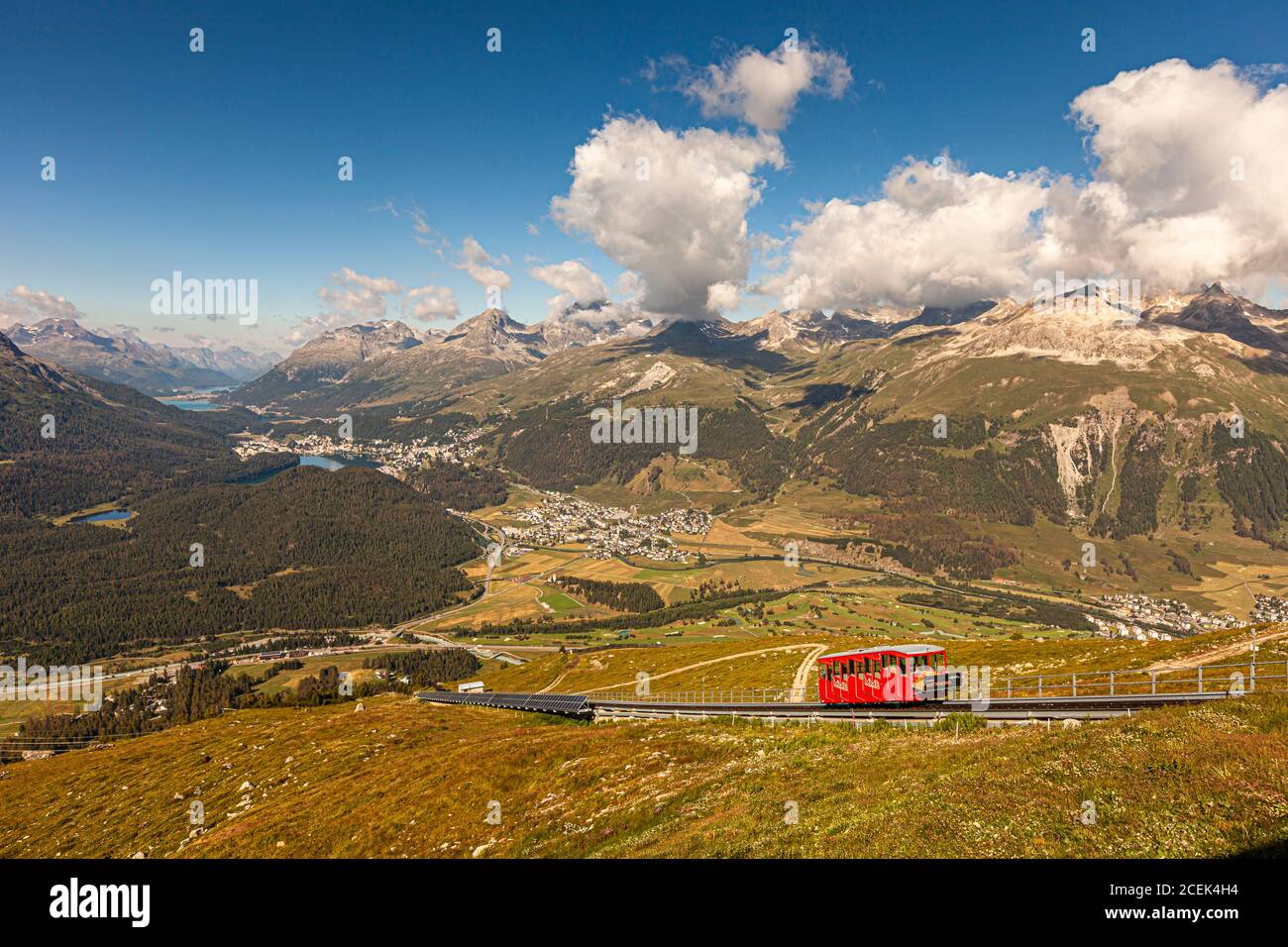 The Muottas Muragl cable car in Graubünden, Switzerland. View from the top station of Muottas Muragl: Down in the valley on the left is Pontresina, where German Chancellor Angela Merkel regularly recuperates. In the valley to the right, lined up along the lakes, are the towns of Celerina, St. Moritz and, in the background, Silvaplana Stock Photo