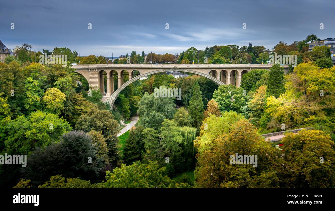 Pont Adolphe (Adolphe Bridge) and Vallé de la Pétrusse (Petrusse Park), in the distance in the city of Luxumbourg Stock Photo