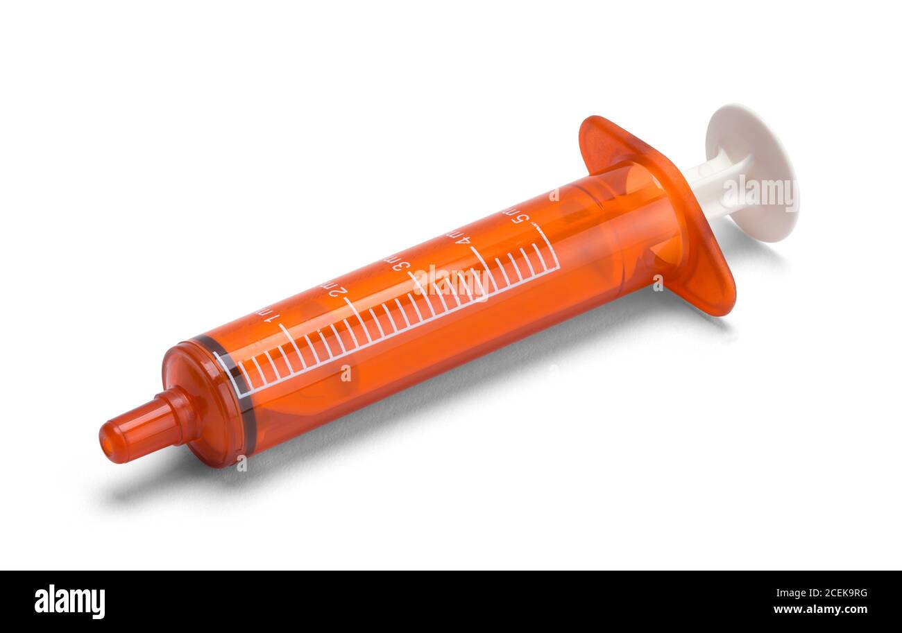Orange Oral Syringe on Side Isolated on White Background. Stock Photo