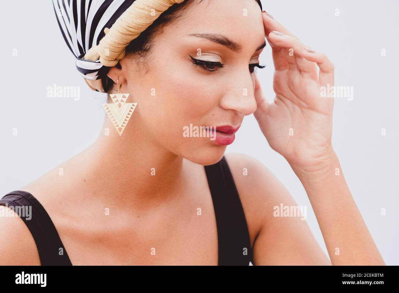 Young Woman in kerchief on head standing on rooftop Stock Photo
