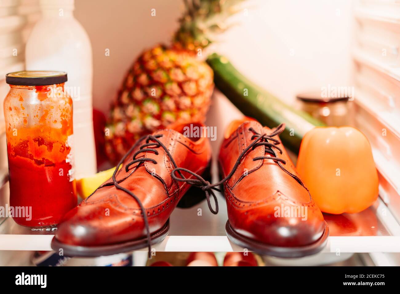 Shoes and food into a refrigerator for fools day Stock Photo