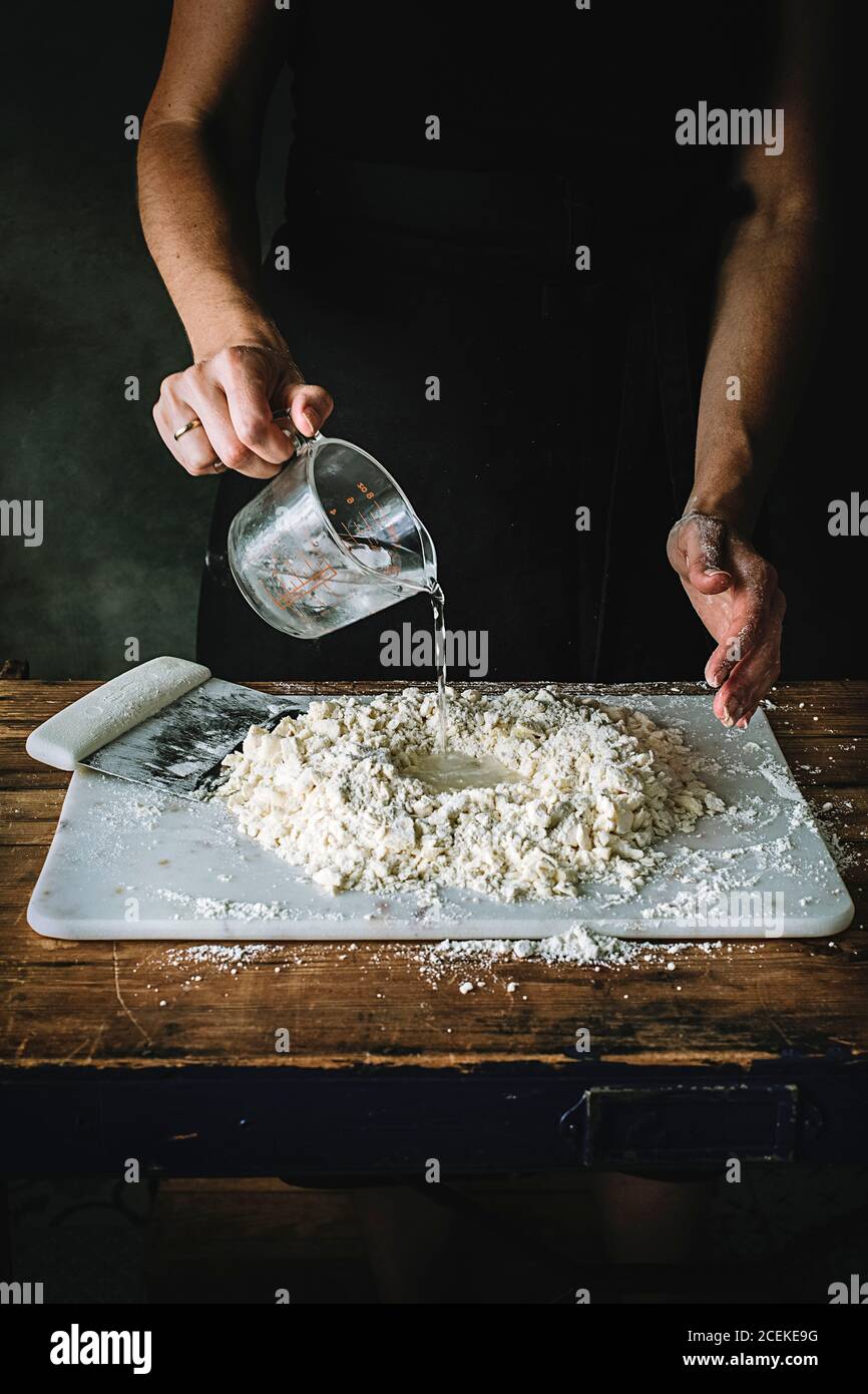 Mixing together ingredients of hot-water crust pastry dough, using wooden  spoon Stock Photo - Alamy