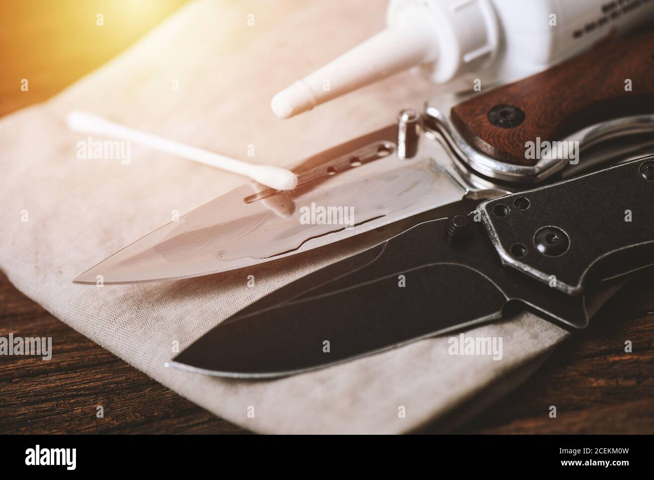 The man oiling his pocket knife. Pocket knife care and maintenance concept Stock Photo Alamy