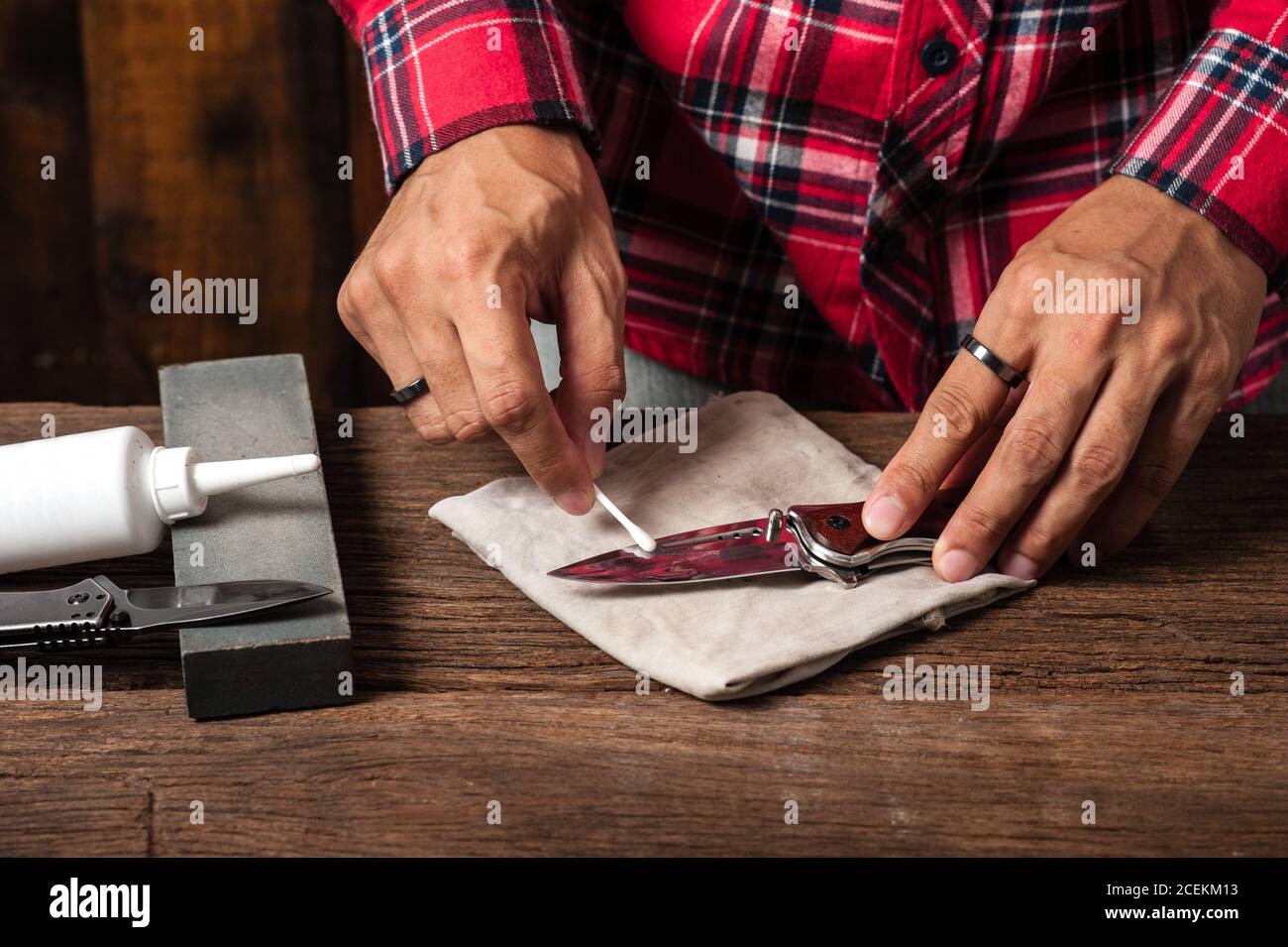 The man oiling his pocket knife. Pocket knife care and maintenance
