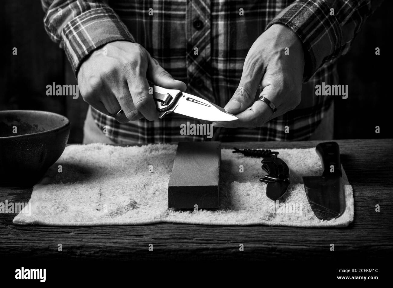Premium Photo  The man using whetstone to sharpening his pocket knife  pocket knife care and maintenance concept