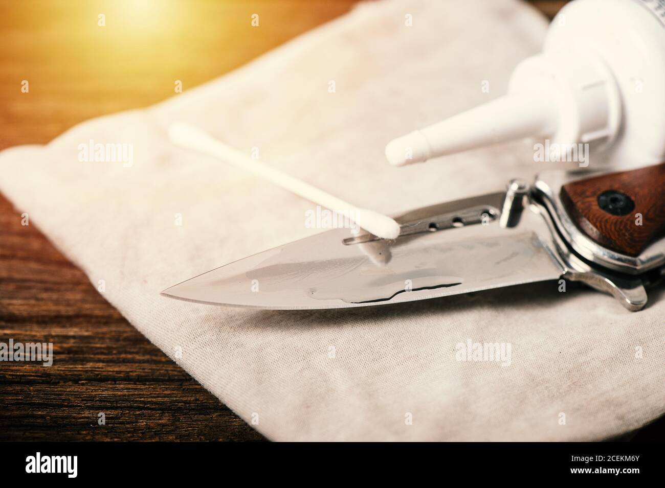 The man oiling his pocket knife. Pocket knife care and maintenance