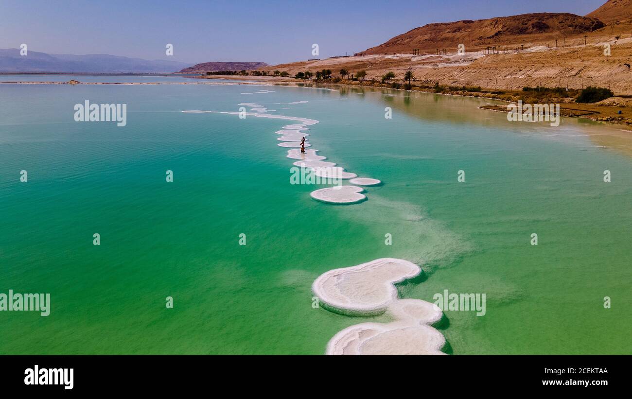 loving couple is resting on the dead sea. Salt coastline, The sea in Israel dies out and dries up Stock Photo