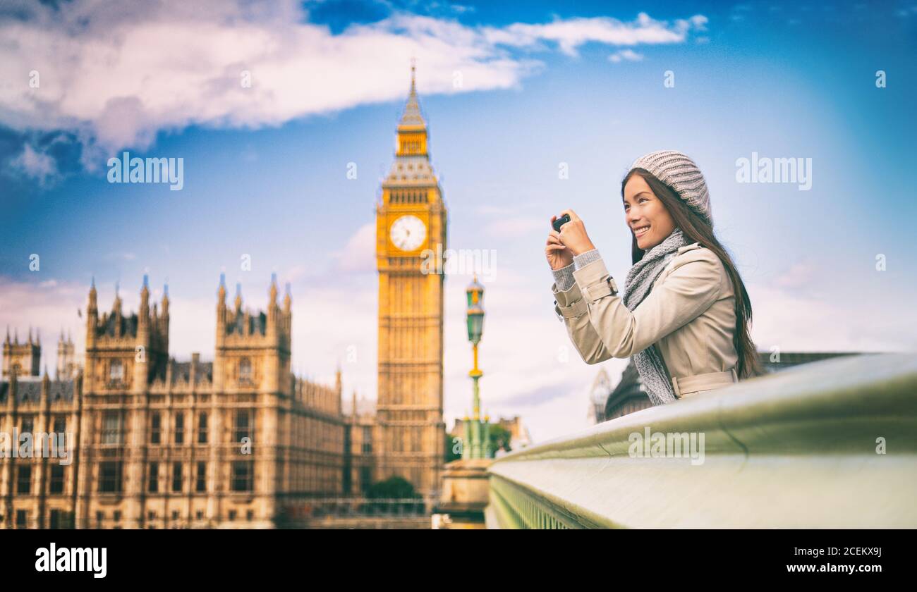 London europe travel woman taking pictures with phone. Mobile photography. Tourist holding smartphone camera taking photos at Big Ben, Westminster Stock Photo