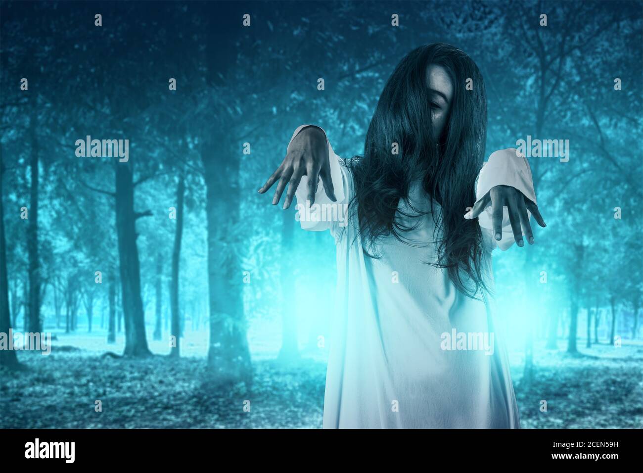 Scary ghost woman standing with haunted forest background. Halloween  concept Stock Photo - Alamy