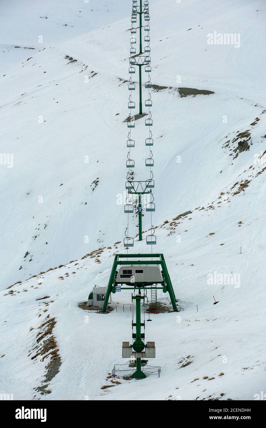 Chair ski lift in South island, New zealand with snow covered the mountains. Stock Photo