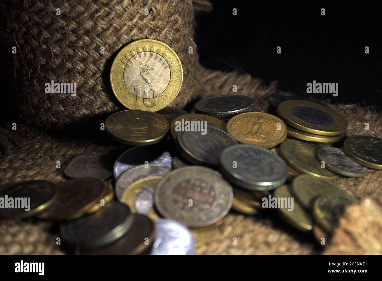 Stock pile of 1, 2, 5, 10 Indian rupee metal coin currency isolated on sack background. Financial, economy, Banking and exchange investment concept. Stock Photo