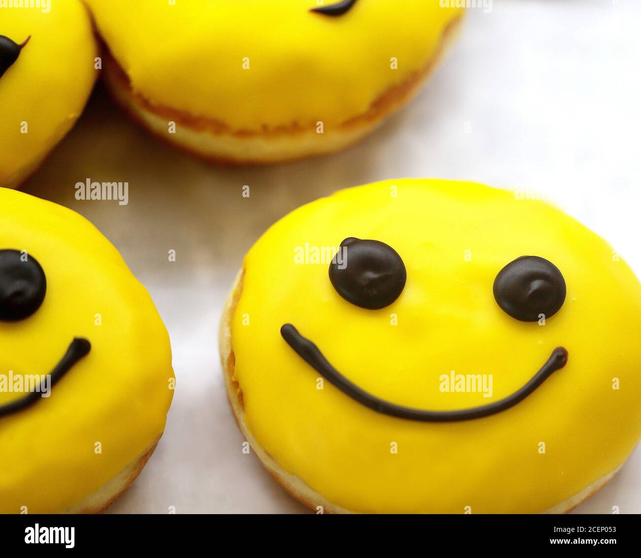 Photo background of delicious sweet doughnuts with faces on display Stock Photo
