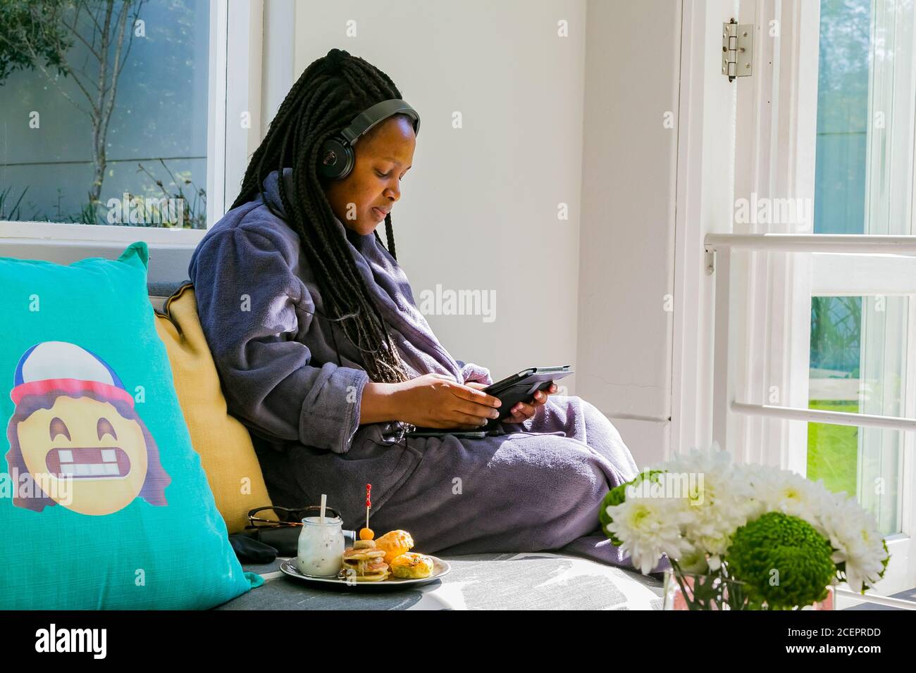 Johannesburg, South Africa - May 10, 2018: Young African woman in bath robe  watching streaming service on tablet computer at spa resort Stock Photo -  Alamy