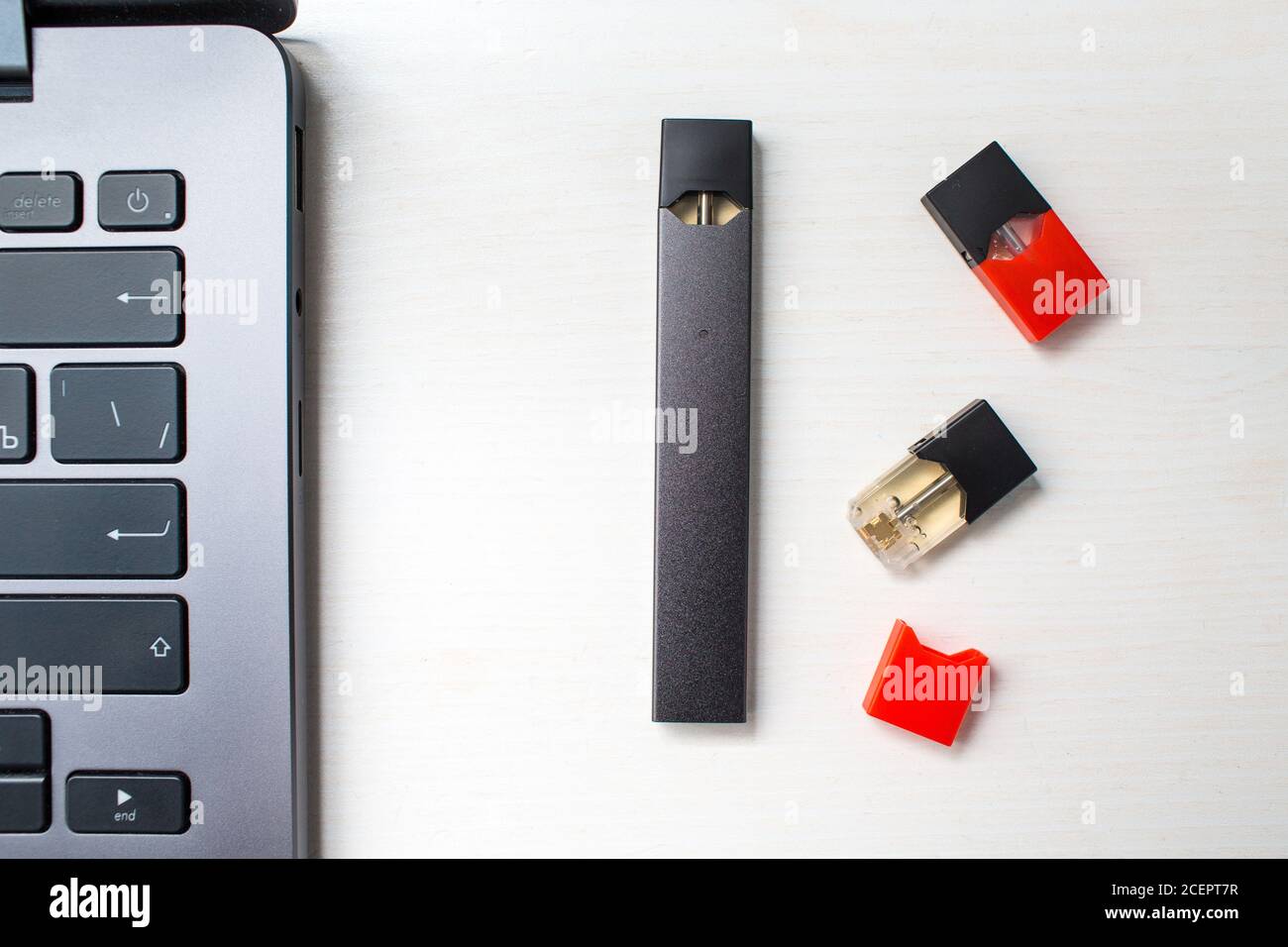 MOSCOW - 26 June 2020: Juul e-cigarette nicotine vapor stick and laptop Stock Photo