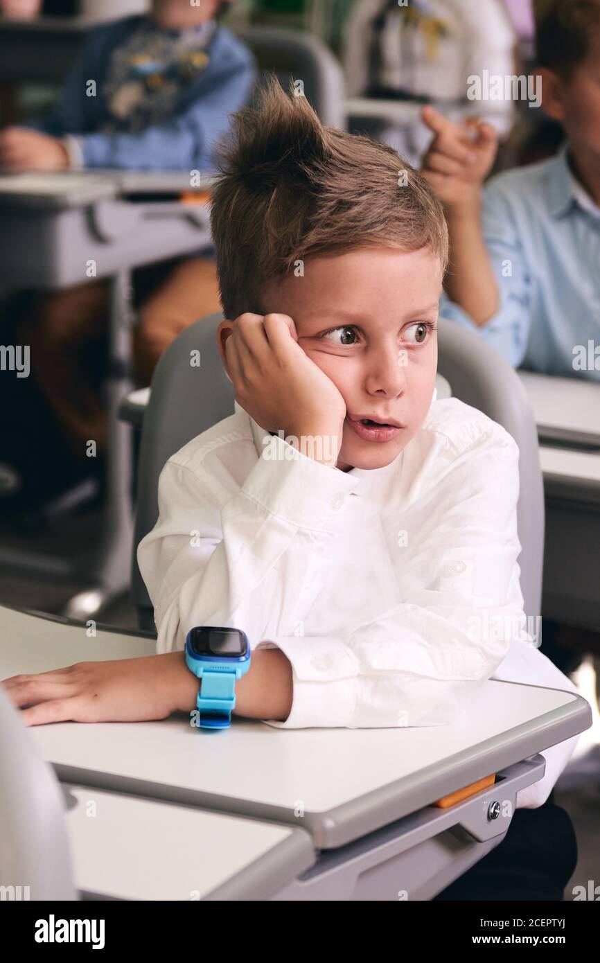 Upset and boring caucasian 6 years boy. Pupil of primary school in