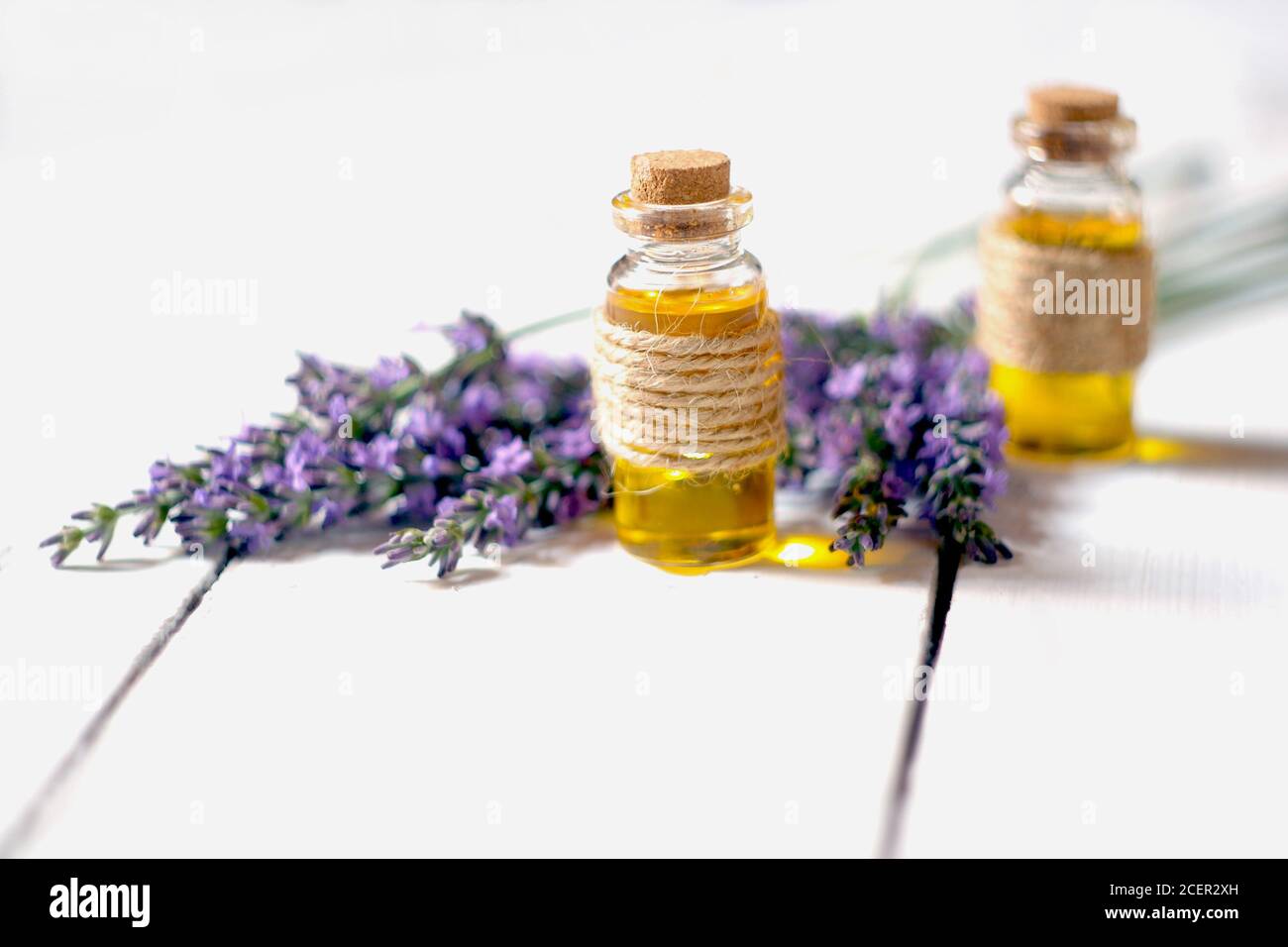 Lavender oil and lavender flowers on white background Stock Photo - Alamy
