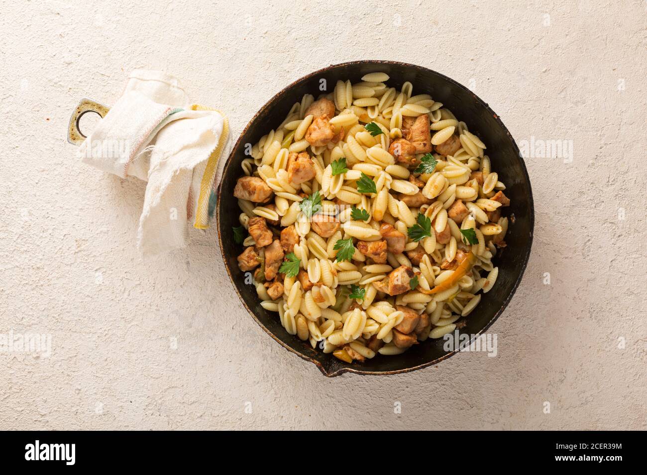 Gnocchi pasta with chicken, herbs in a pan. Italian cooking. cilantro