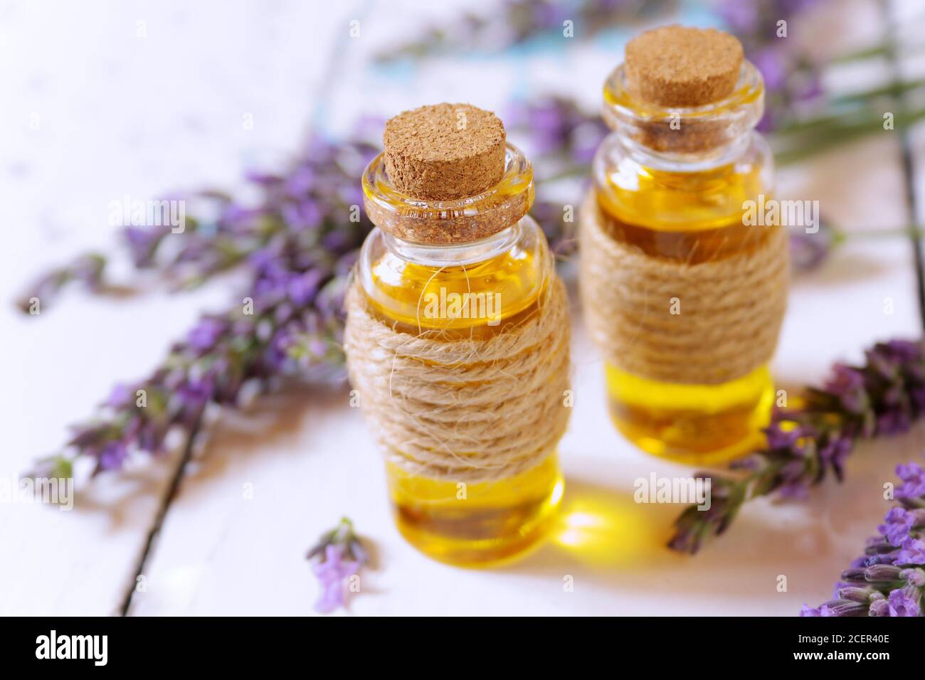 Lavender oil and lavender flowers on white background Stock Photo - Alamy