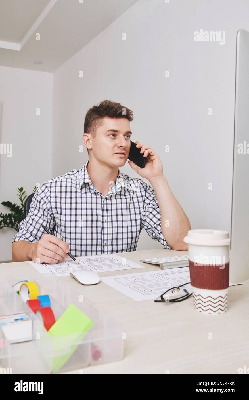 UI designer calling to client Stock Photo