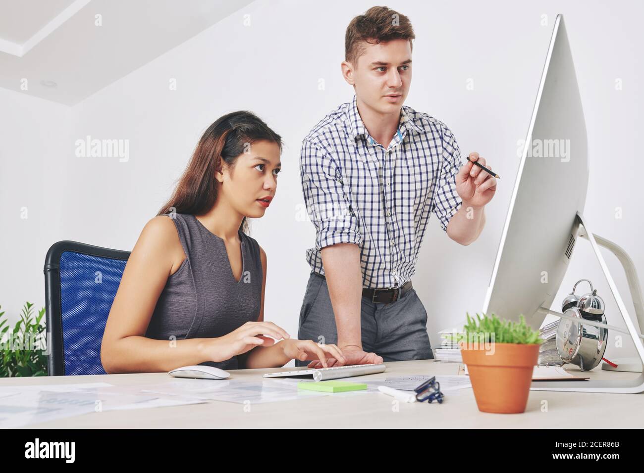 Designers discussing website interface Stock Photo