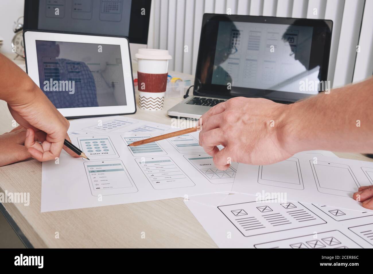 Designers discussing interface layouts Stock Photo