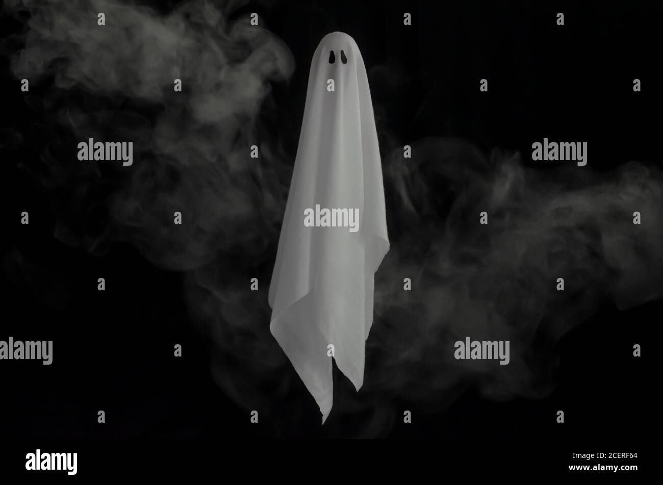 White Ghost Sheet Flying In Dark Background With Smoke Halloween Scary   White Ghost Sheet Flying In Dark Background With Smoke Halloween Scary Concept 2CERF64 