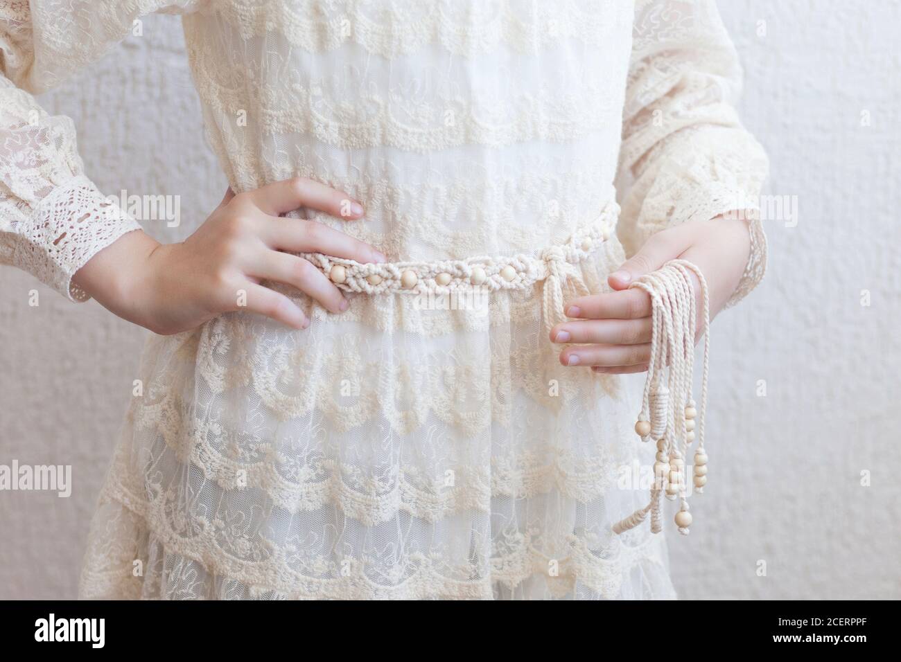 Handmade macrame dress belt. Natural cotton threads and wooden beads.  Stylish decoration for women 's dress. Macrame braiding and cotton threads.  Fem Stock Photo - Alamy