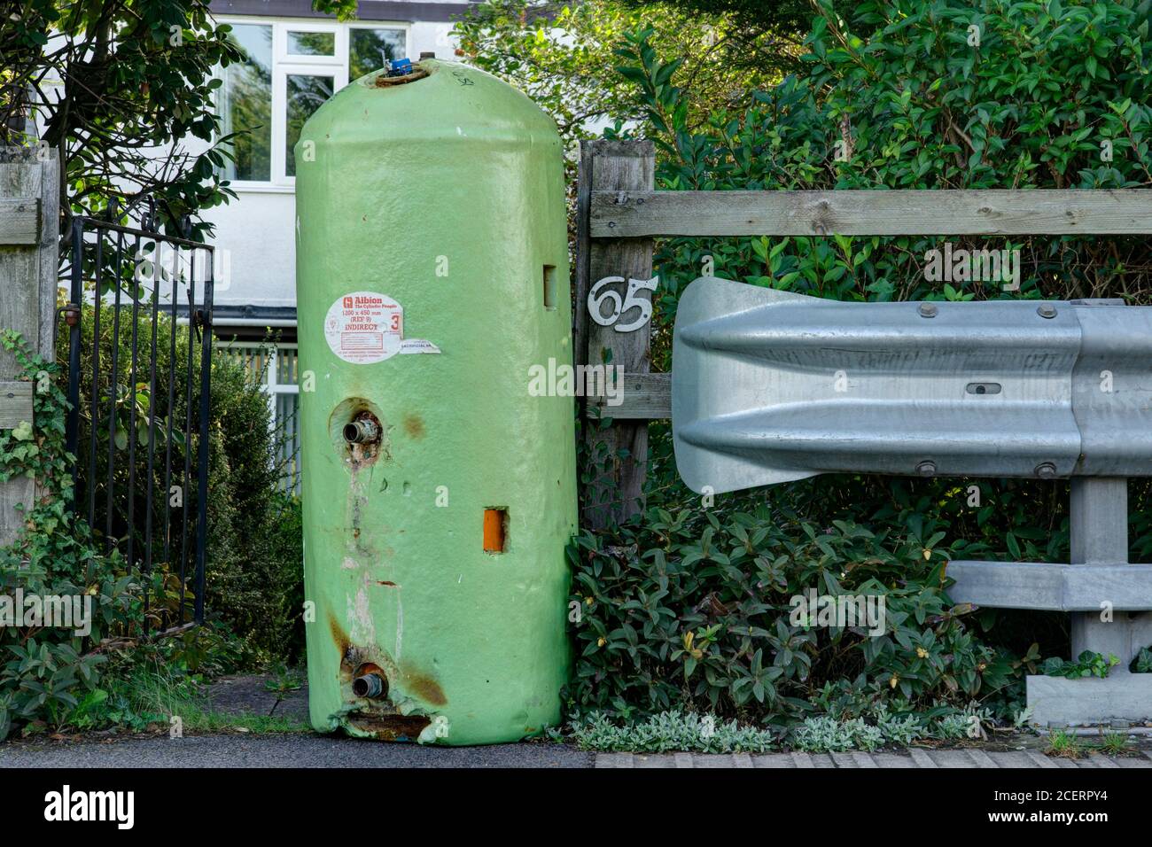 Green hot water tank ready for disposal Stock Photo Alamy