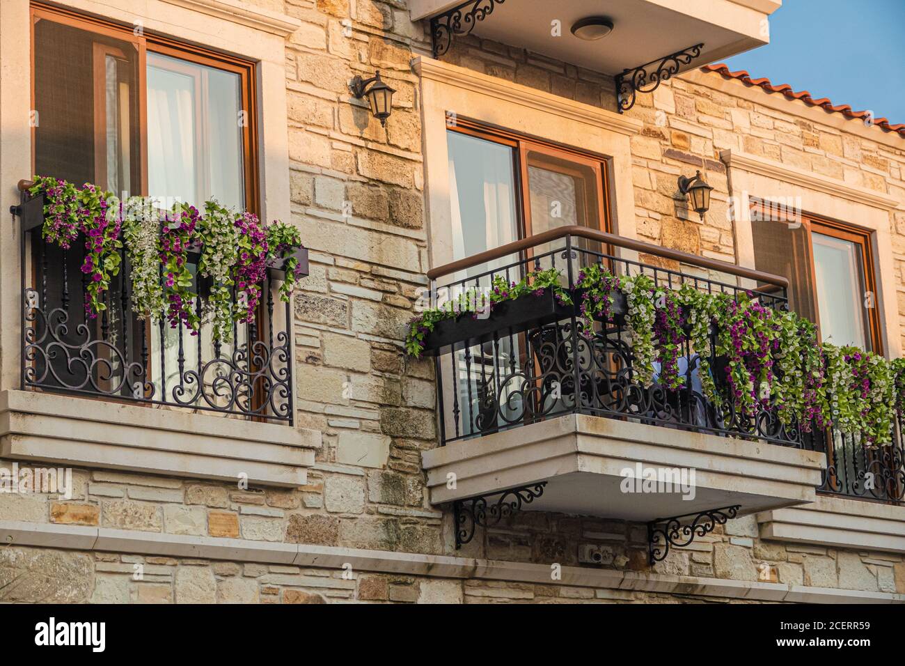 French balcony with beautiful flowers taken before sunset. Stock Photo