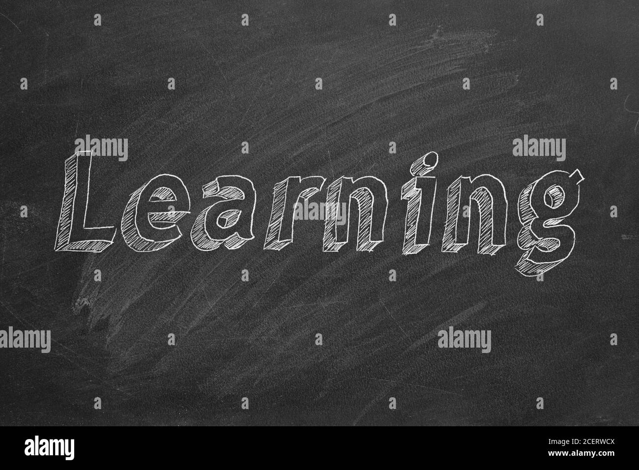 Hand drawing 'Learning' on black chalkboard Stock Photo