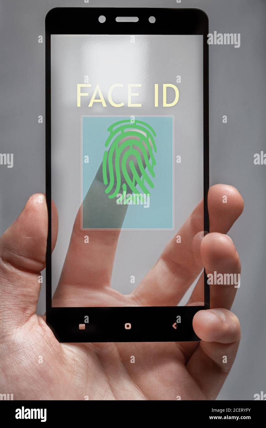 the phone requires user authentication. as a face or fingerprint scan Stock Photo