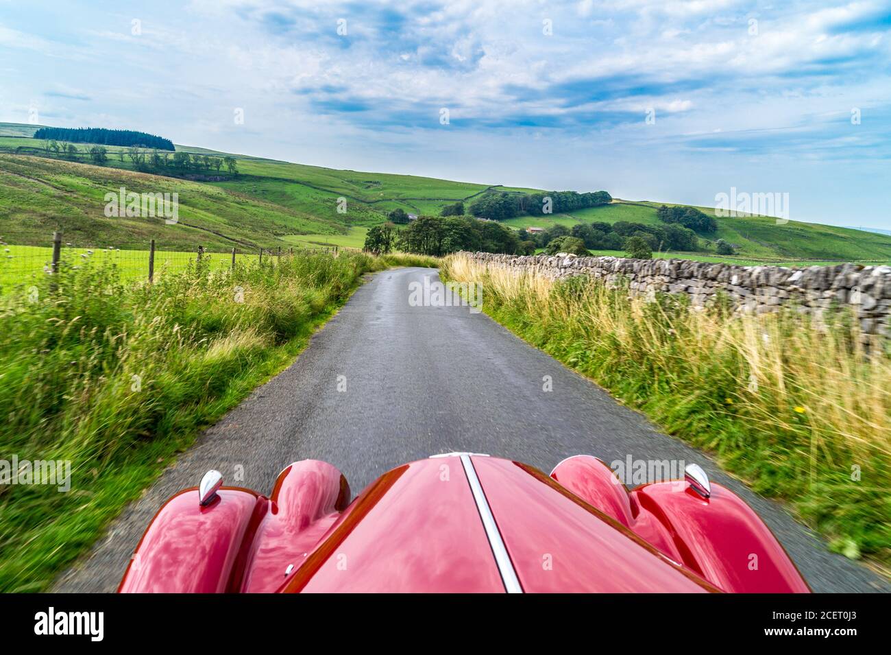 View of the road ahead, 2003 model Morgan 4/4 drop-head coupé sports car, Stainforth, North Yorkshire, England Stock Photo