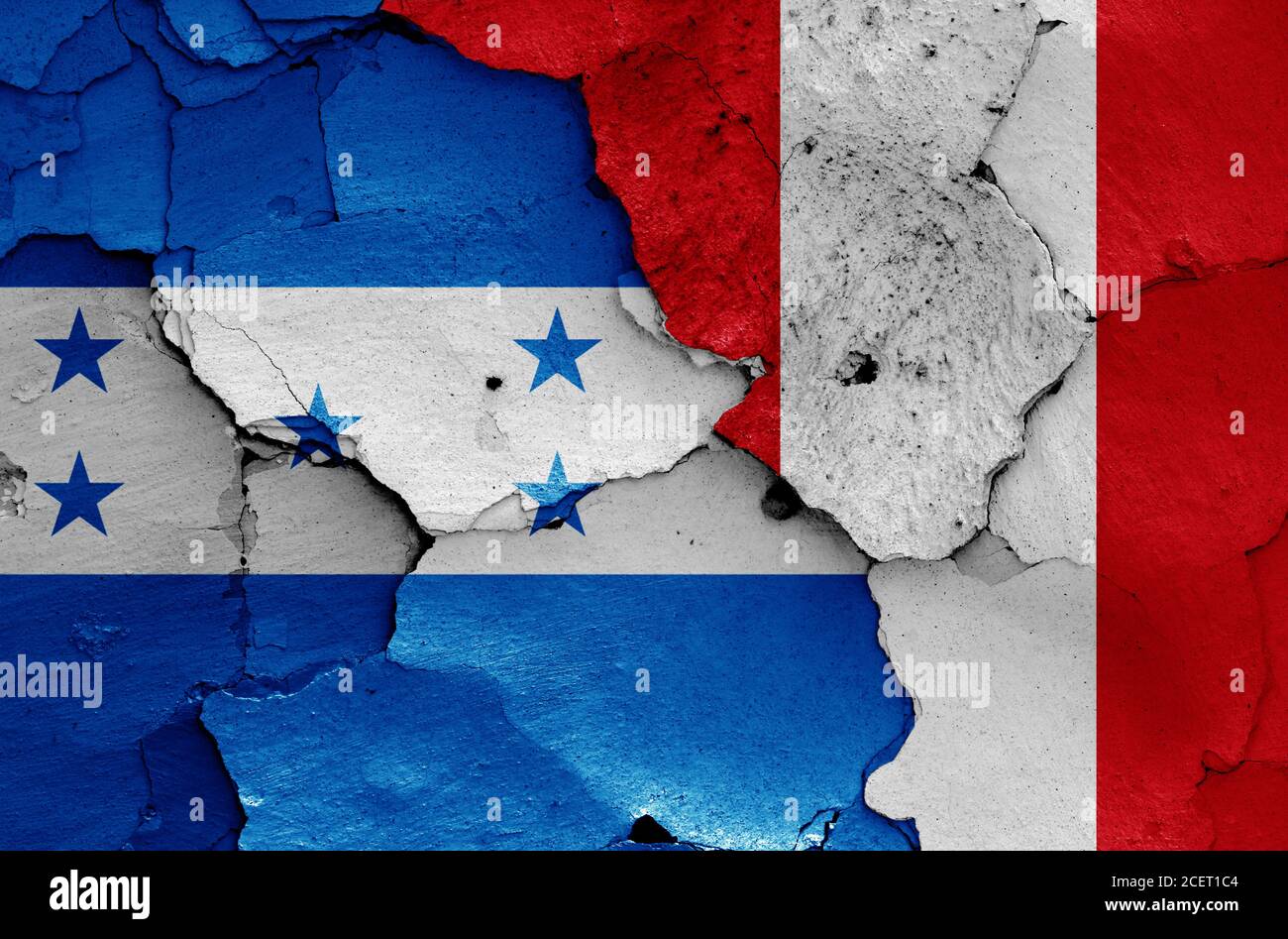 flags of Honduras and Peru painted on cracked wall Stock Photo
