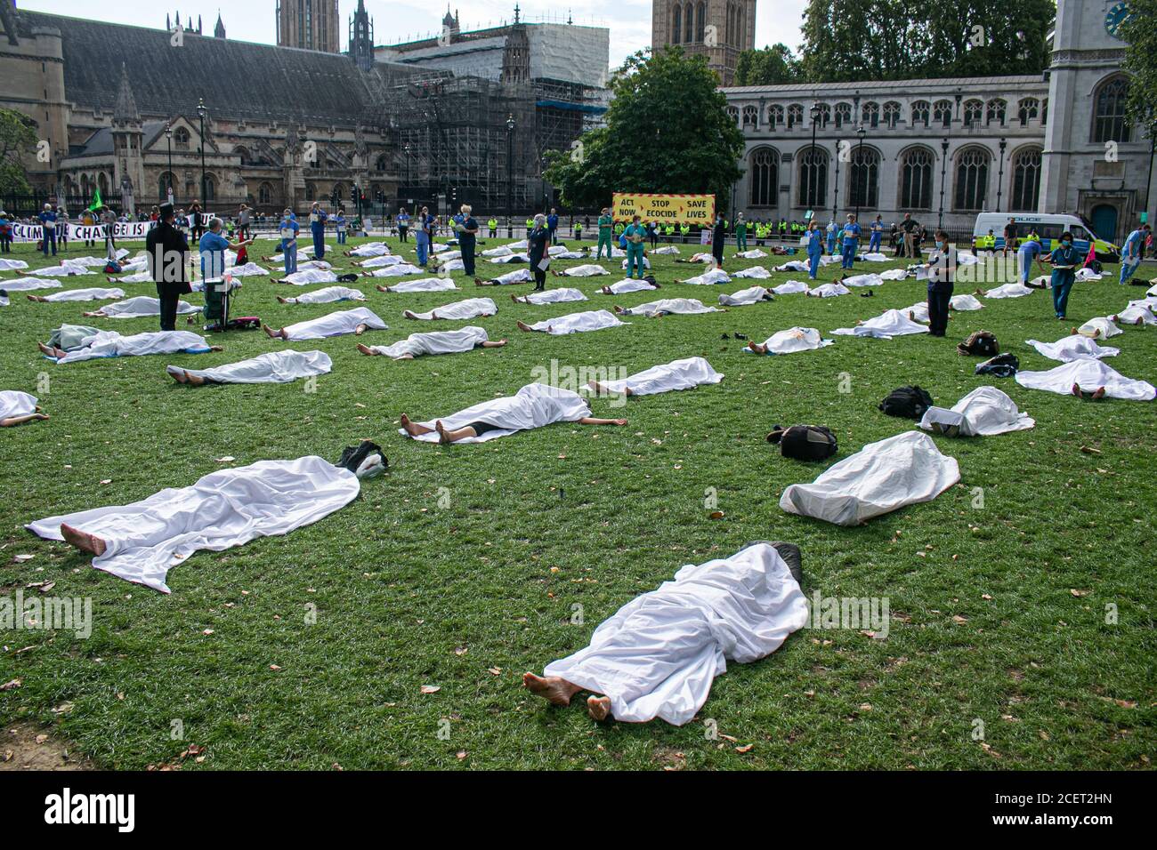 WESTMINSTER LONDON, UK - 2 September 2020 Climate activists from Extinction rebellion lying as a dead body under a white shroud  in Parliament Square. Extinction Rebellion have vowed  to continue protests over 12 days in London  due to the government’s failure to act on the climate and ecological emergency and demand the government act now  and to support the Climate and Ecological Emergency Bill. Credit: amer ghazzal/Alamy Live News Stock Photo