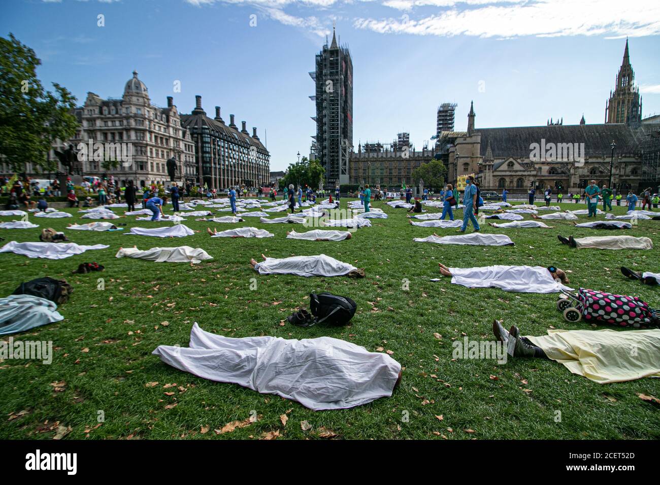 WESTMINSTER LONDON, UK - 2 September 2020 Climate activists from Extinction rebellion lying as a dead body under a white shroud  in Parliament Square.Extinction Rebellion have vowed  to continue protests over 12 days in London  due to the government’s failure to act on the climate and ecological emergency and demand the government act now  and to support the Climate and Ecological Emergency Bill. Credit: amer ghazzal/Alamy Live News Stock Photo