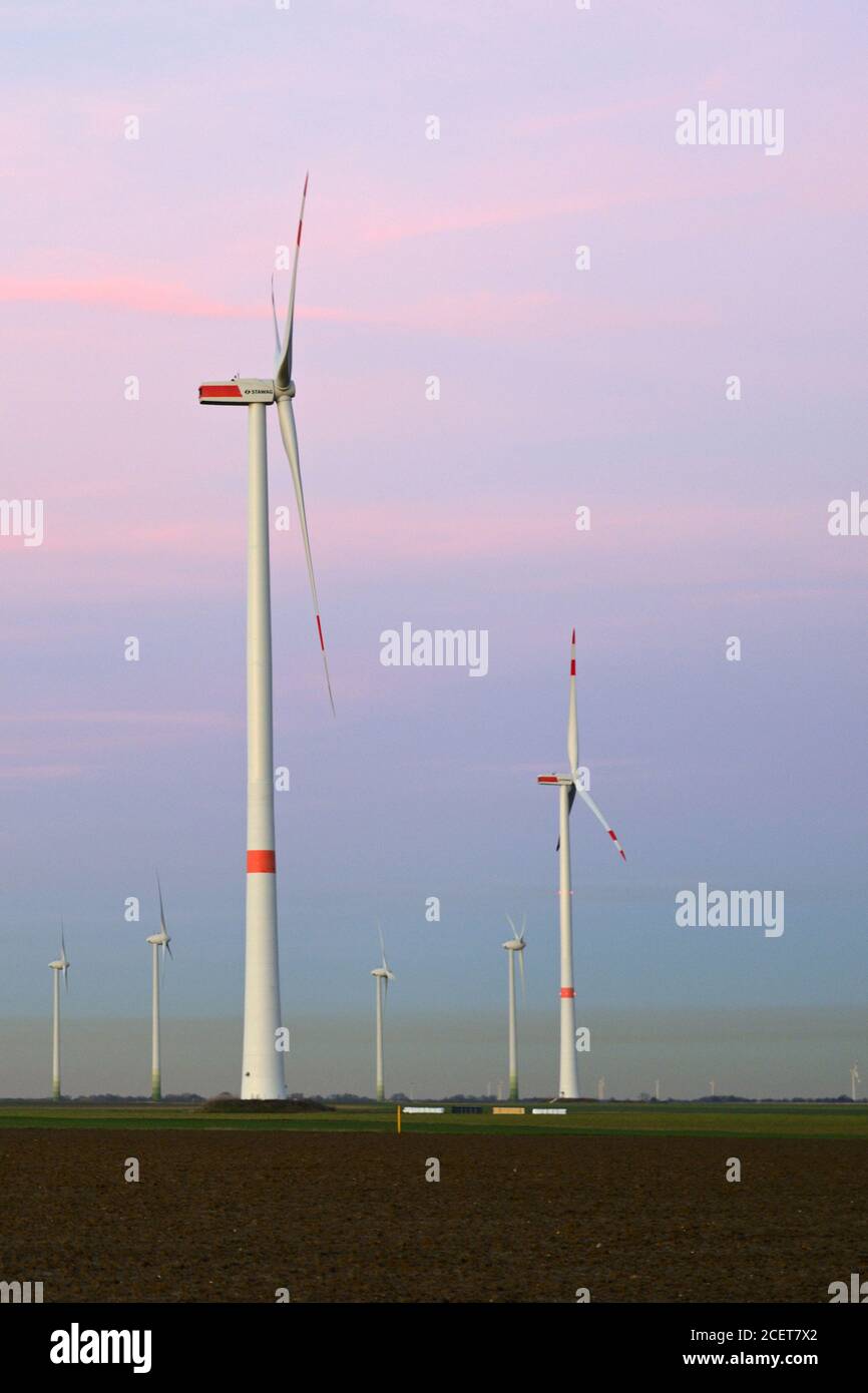 Wind turbines, park of wind turbines, windpark, windmills, wind power on farmland, renewable Energy with polluted air over the horizont, NRW, Germany. Stock Photo