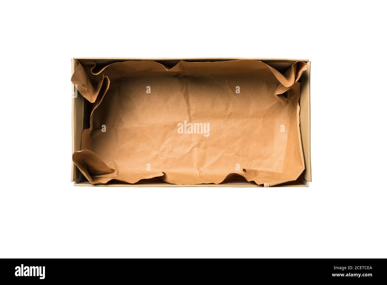 Shoe box isolated on a white background. Open cardboard box for shoes or gift with crumpled brown paper. Concept of delivery of goods, purchases via Stock Photo