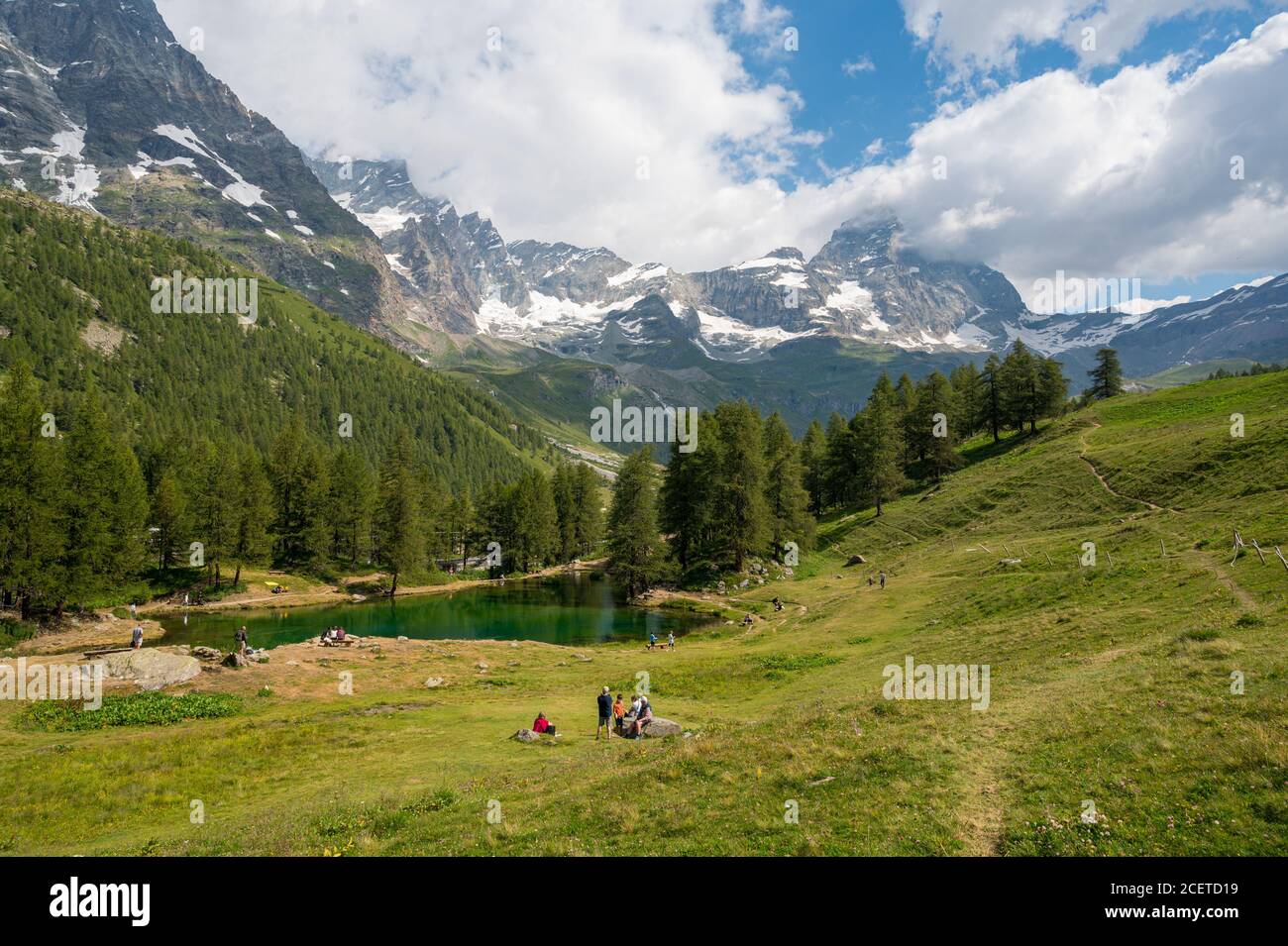 Cervinia, Italy - July 21, 2020: People enjoying Cervinia countryside with views of Matterhorn at Lago Blu Stock Photo