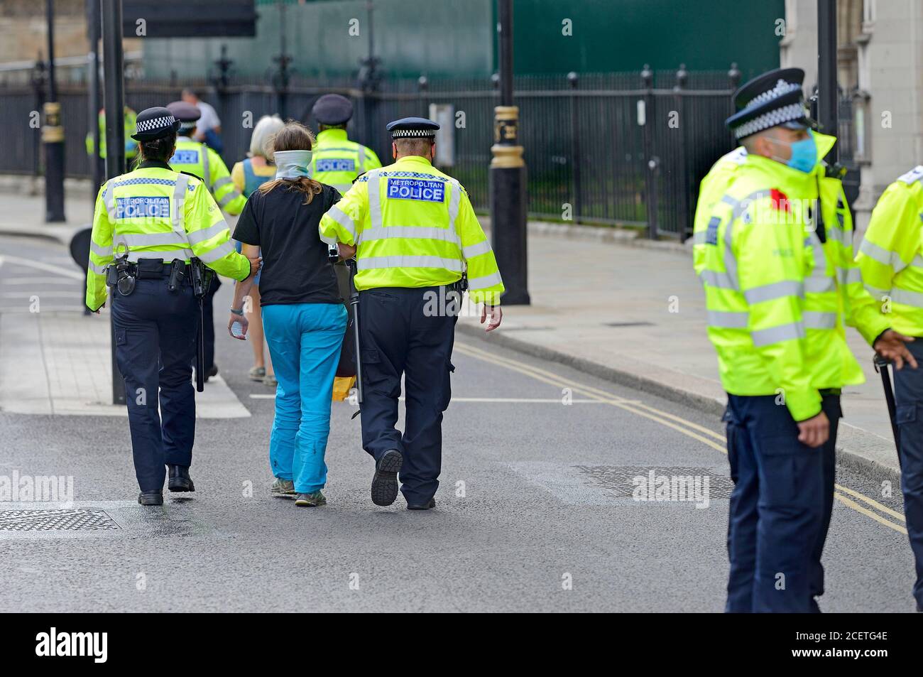 London, UK. Protester being led away after being arrested at an Extinction Rebellion protest in Parliament Square, 1st September 2020 Stock Photo