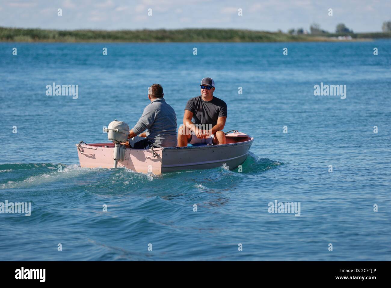 Two men fishing in motor boat hi-res stock photography and images