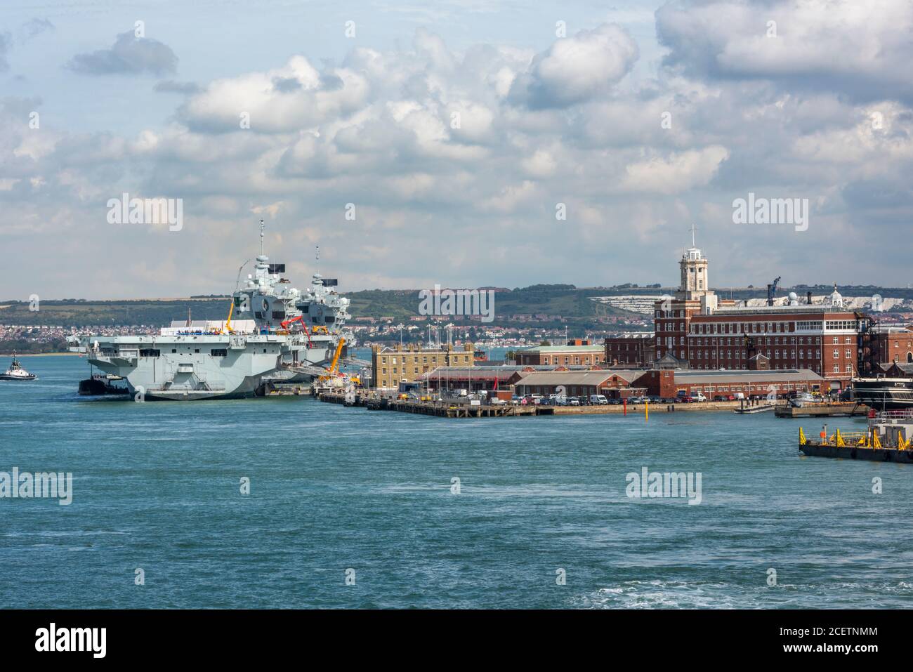 the royal navy warship aircraft carrier alongside in portsmouth naval
