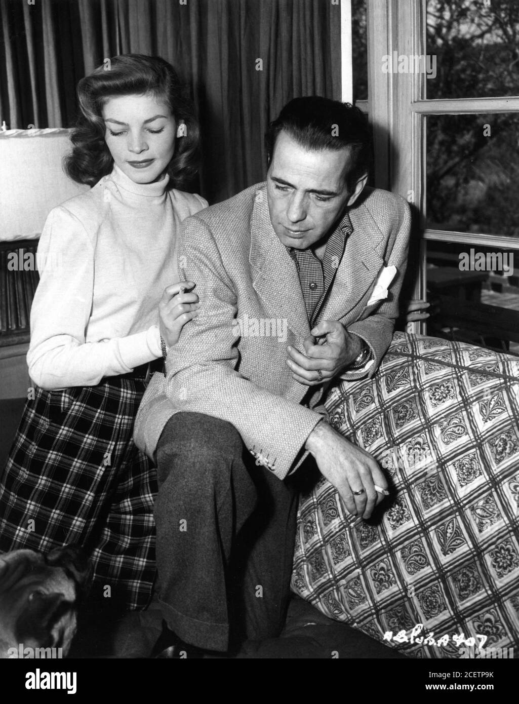 HUMPHREY BOGART and LAUREN BACALL 1945 newlyweds candid portrait at home Benedict Canyon Los Angeles publicity photo from Warner Bros. Stock Photo